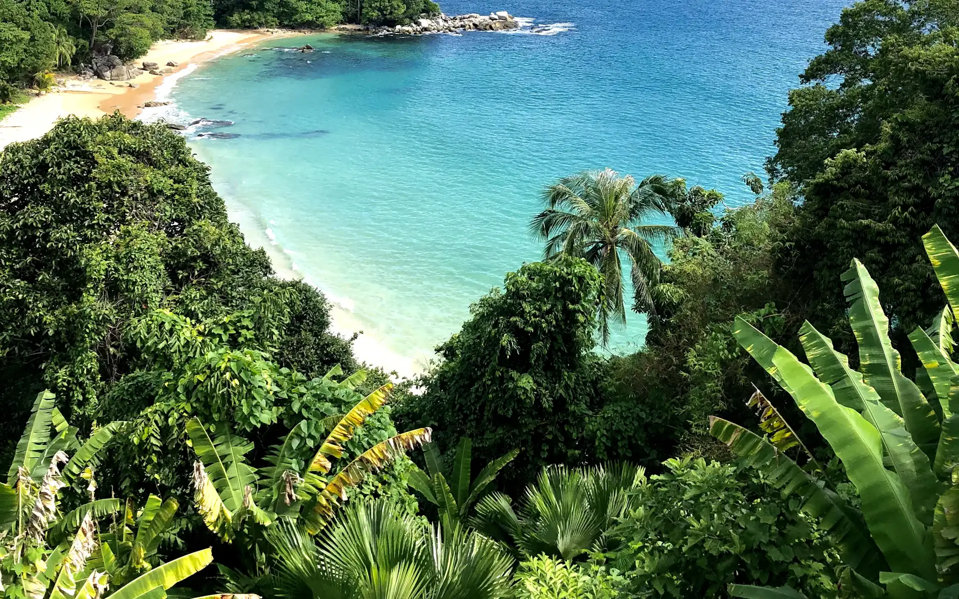 A snow-white beach and azure sea from above