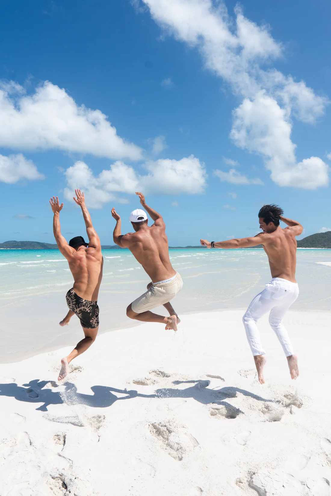Friends running on white sand